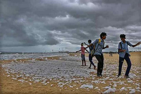 Teenagers playing with the foam at the beach near Napier Bridge on Friday.(Photo: Justin George)