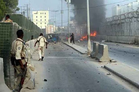 Somali security officers attempt to secure the scene of an explosion in Mogadishu