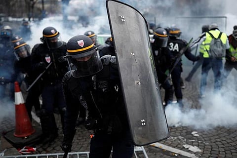 French police fire tear gas at protesters on Champs Elysees