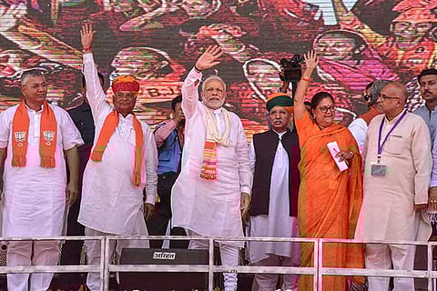 PM Modi with Rajasthan CM Vasundhara Raje wave at their supporters in Ajmer