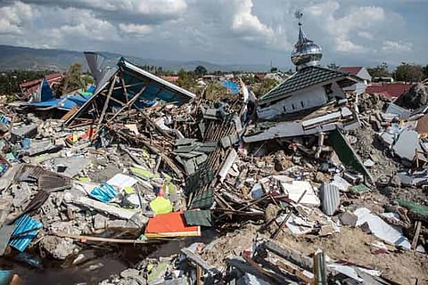 Indonesia considers making devastated areas mass graves