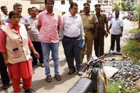 Kiran Bedi, accompanied by officials, inspects an open drain in Puducherry on Saturday