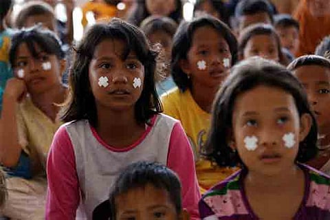 Children trickle back to school in Indonesia quake city to find friends