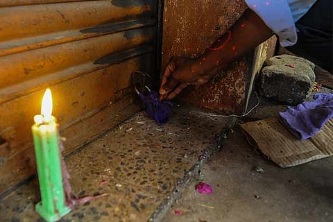 An official seals a shop shut in Flower Bazaar on Thursday