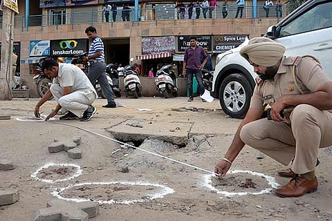 Police investigate after a judge's wife and son were shot at by their own gunman in Gurugram