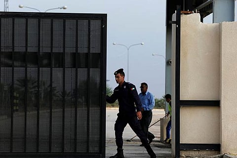 A Jordanian policeman opens the gate of Jordan's Jaber border crossing near Syria's Nasib checkpoint