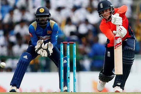 England's Joe Root (R) plays a shot next to Sri Lanka's wicketkeeper Niroshan Dickwella