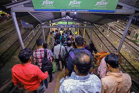 Passengers at a foot-overbridge at Santragachi Station where a stampede took place