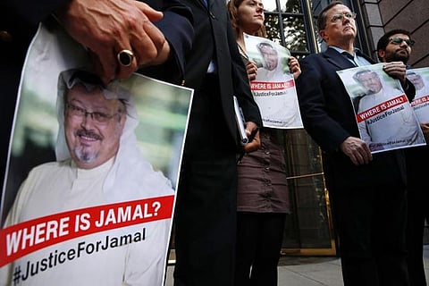 A demonstrator holds picture of Saudi journalist Jamal Khashoggi during a protest