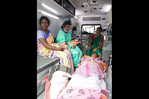 M Sathya with the twin baby girls and amublance attendants on a 108 vehicle near Vellore