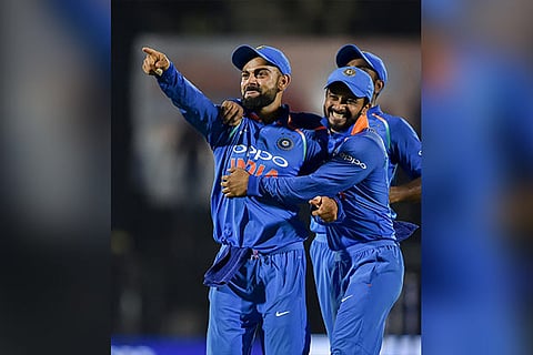 Virat Kohli celebrates with his teammates the dismissal of West Indies batsman Kieran Powell