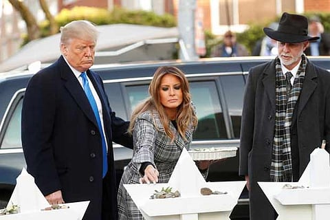 Trump visits Pittsburgh synagogue after shooting, protesters cry foul