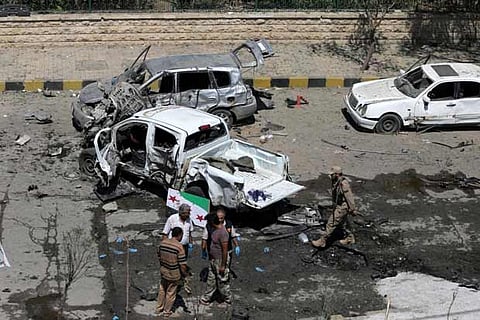 Free Syrian Army (FSA) inspect damaged cars after a car bomb in the Azaz, Syria