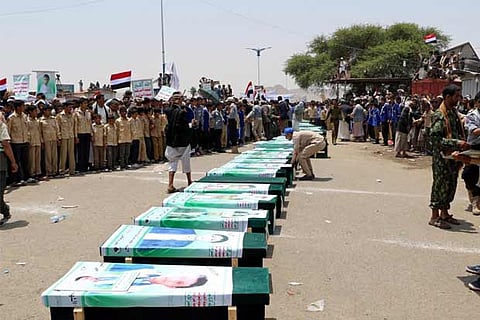 Mourners attend a funeral of people, mainly children, killed in a Saudi-led coalition air strike