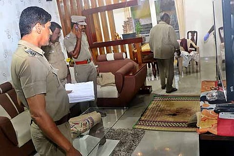 Police inspect the house where the murder was committed in Coimbatore on Monday
