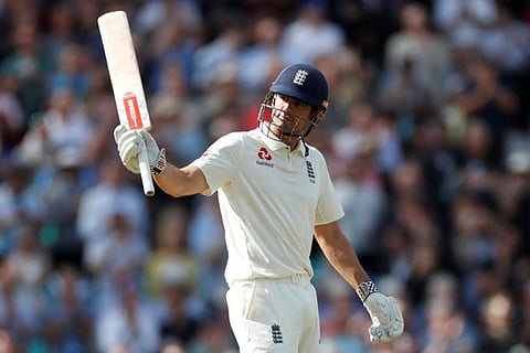 England's Alastair Cook celebrates after reaching a half century