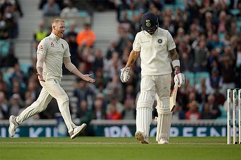England's Ben Stokes celebrates taking the wicket of India captain Virat Kohli