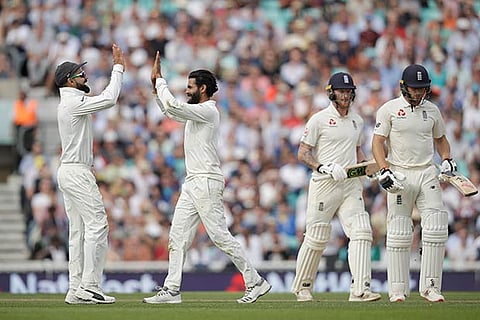 Ravindra Jadeja celebrates taking the wicket of Jos Buttler with India captain Virat Kohli