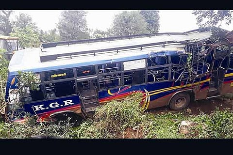 Mangled remains of the private bus that rammed a tree at Kadambur in Erode district on Monday