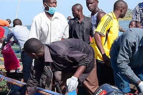 Rescue workers retrieve bodies from water after a ferry overturned in Lake Victoria, Tanzania