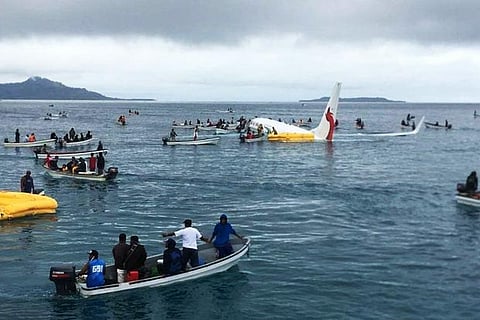 People are evacuated from an Air Niugini plane crashed in the waters in Weno, Chuuk, Micronesia