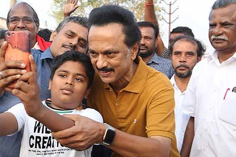 DMK leader MK Stalin obliges a boy with a selfie in Tirupur on Wednesday
