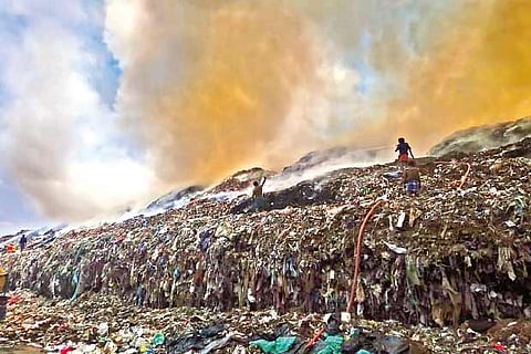 TNFRS personnel fighting flames at the dump yard in Ariyamangalam