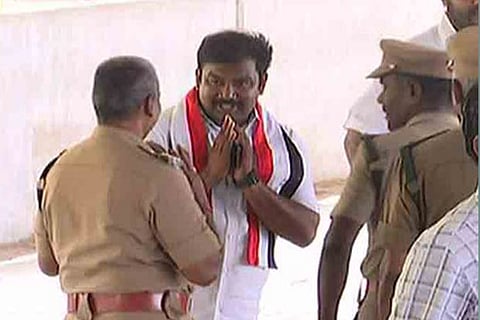 VVR Raj Satyen seen greeting police personnel at a postal polling booth in Madurai on Wednesday