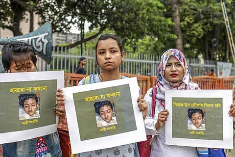 Bangladeshi women hold placards and photographs of schoolgirl Nusrat Jahan Rafi at a protest