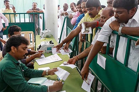 AIADMK workers buy applications for contesting in the bypolls for four Assembly seats at the party headquarter