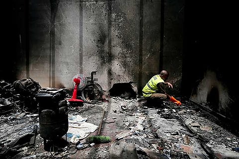 A Sri Lankan policeman inspects the site of a gun-battle between troops and suspected militants