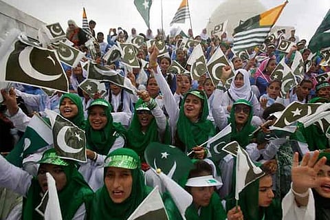 Pakistani students wave Pakistani and Kashmiri flags. File photo: AP
