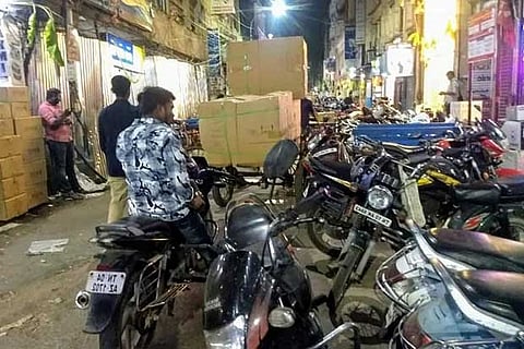Two-wheelers parked on the narrow lane
