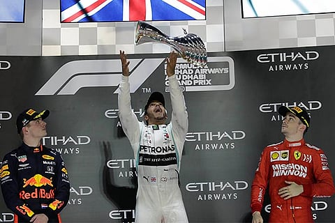 Lewis Hamilton (centre) is elated after winning the Abu Dhabi GP