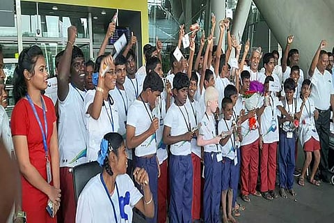 Students cheer after sharing their on-flight experience with others at Chennai airport on Tuesday