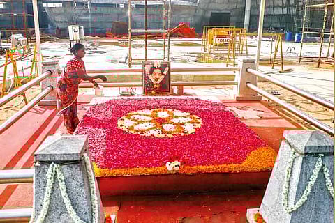 A worker decorating former chief minister Jayalalithaa?s memorial ahead of her third death anniversary