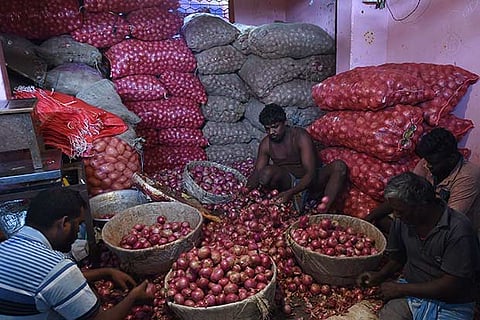 Workers at Koyambedu market seggregate onions