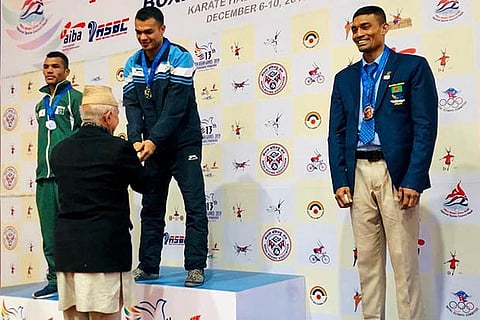 Indian boxer Vikas Krishan (centre) on top of the podium