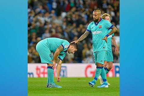 Barcelona players are dejected after the draw against Sociedad