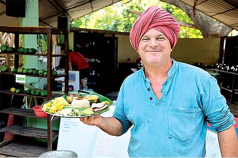 Krishna McKenzie with a thali of locally grown foods