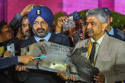 IAF officials show sections of an exploded Amraam missile, said to be fired by Pakistan Air Force F-16s