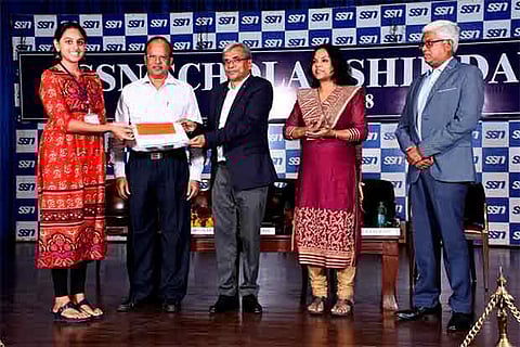 A student receives scholarship on the 20th Annual Scholarship Day