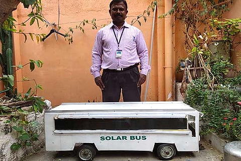 CMC staffer Rajan Charles along with the solar powered bus that he developed in Vellore