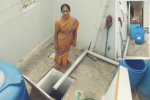 Rajathi beside the water storage tank at her residence in Tirupur