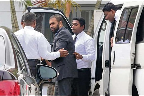 Doctor Segu Shihabdeen Mohamed Shafi is escorted by Criminal Investigation Department officials