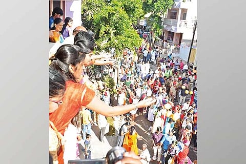 Devotees throw mangoes at the deity during procession in Karaikal