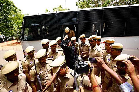 Activist Mugilan, who was brought to Karur court on Monday, raised slogans against Central and state governmen