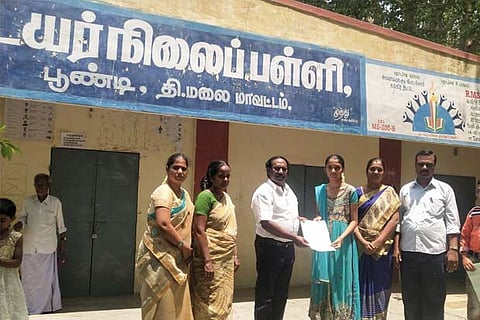 A teacher couple receive certificates after admitting their wards in Poondi Govt School