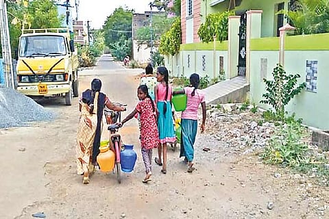 Nandivaram residents taking water to their homes on a bicycle