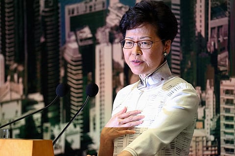 Hong Kong leader apologises as protesters press demands for her to quit